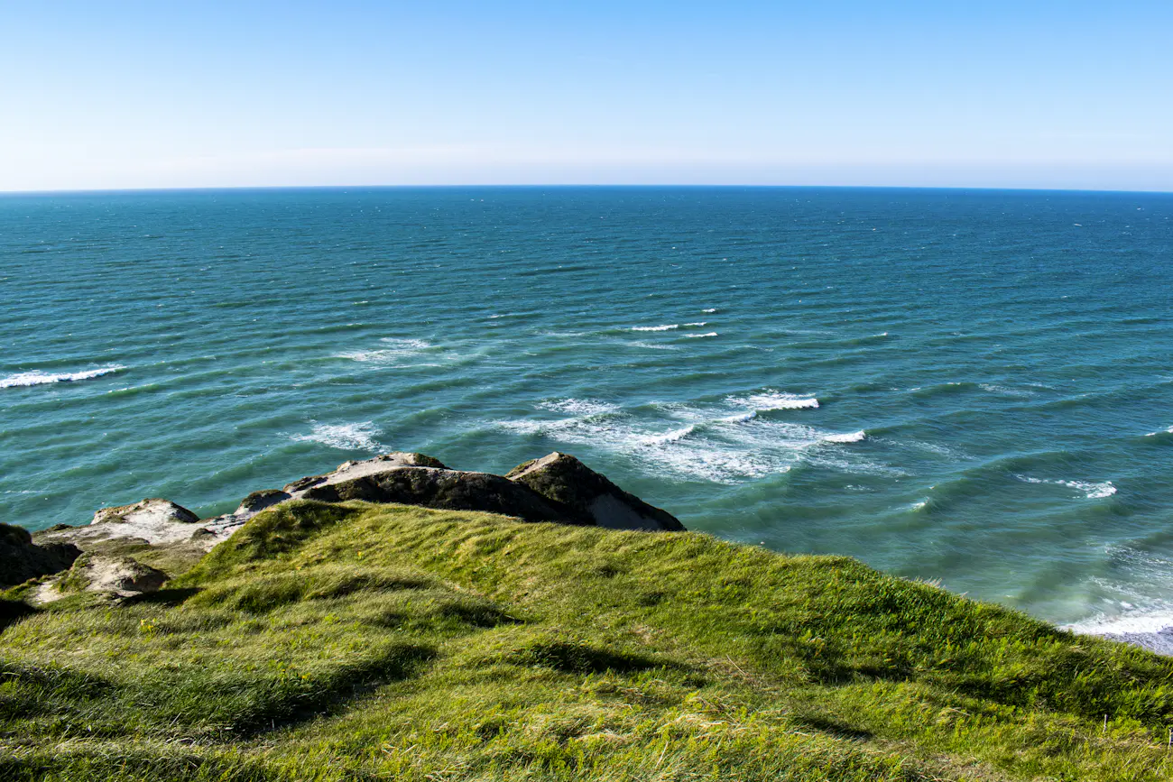Green lawn running down to a view of the blue sea